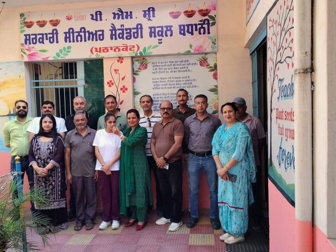Staff at the school entrance, below the PM SHRI Government Senior Secondary School Badhani signboard