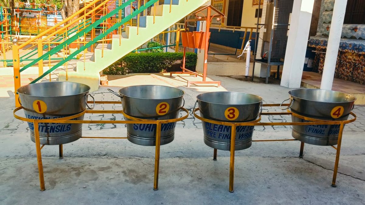 The four-bucket utensil washing station used after the mid-day meal
