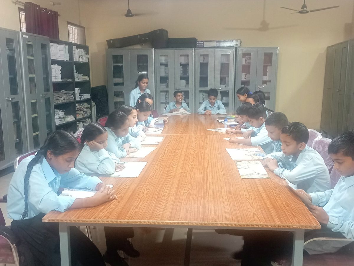 Students reading at the long library table